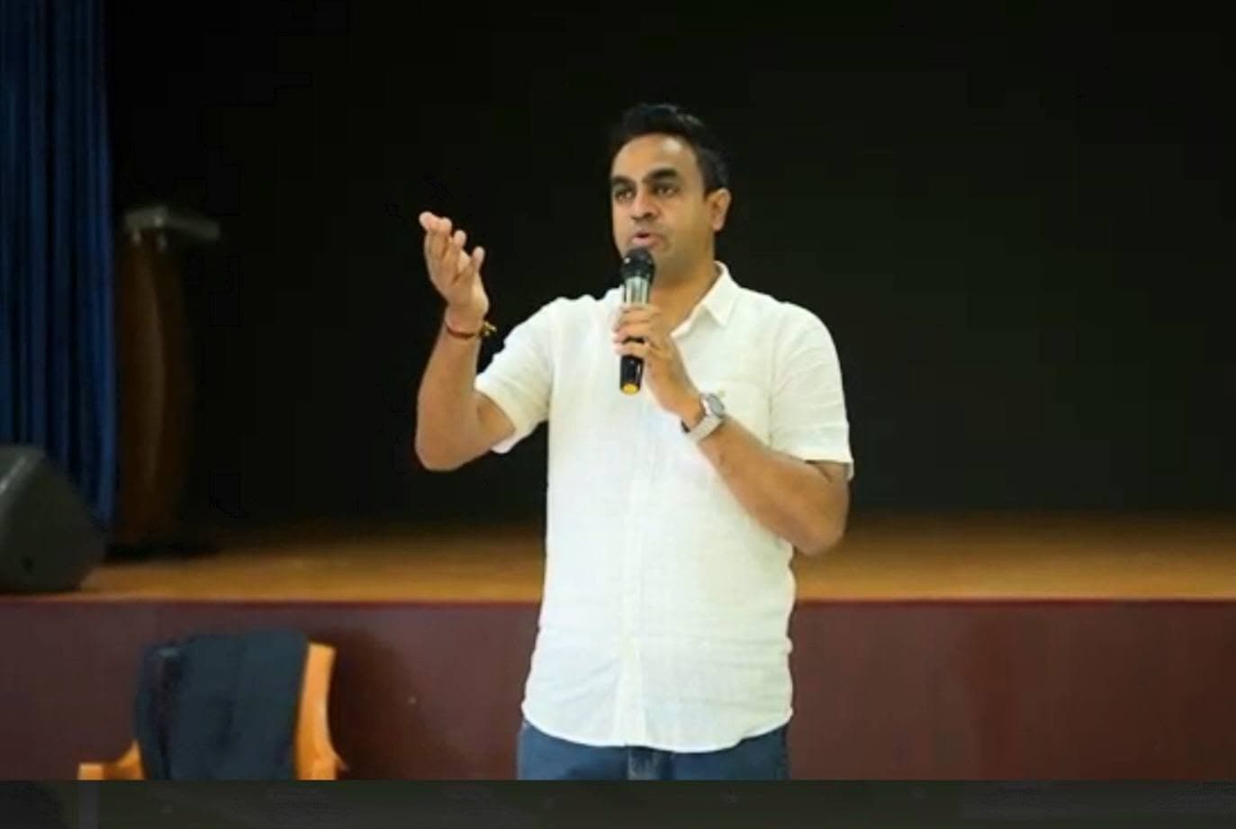 Manesh Chandran addressing students in a college auditorium